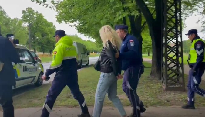 Reportāža: Uzvaras parkā pulcējas plaši policijas spēki; aizturētas divas personas