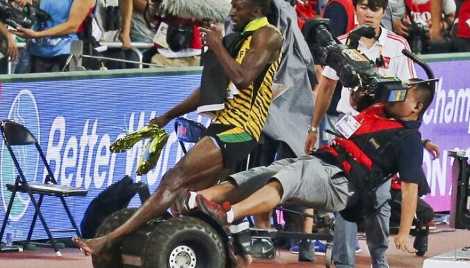 Usain Bolt of Jamaica is hit by a cameraman on a Segway